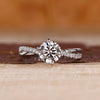 Round cut diamond ring twisted shank pave prong set.
