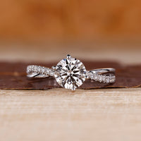 Round cut diamond ring twisted shank pave prong set.
