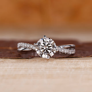 Round cut diamond ring twisted shank pave prong set.
