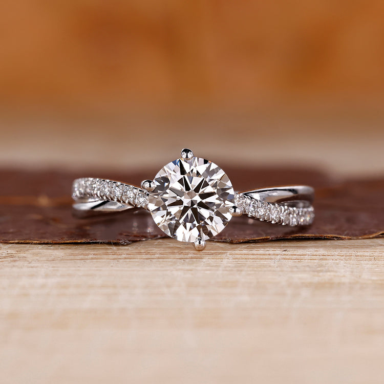 Round cut diamond ring twisted shank pave prong set.
