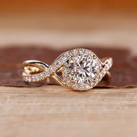 Halo round diamond ring twisted shank four prong.
