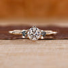 Round cut diamond ring moss agate side stones three stone.
