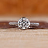 Bezel diamond ring with round centre diamond.
