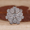Vintage diamond cluster ring with round centre diamond.

