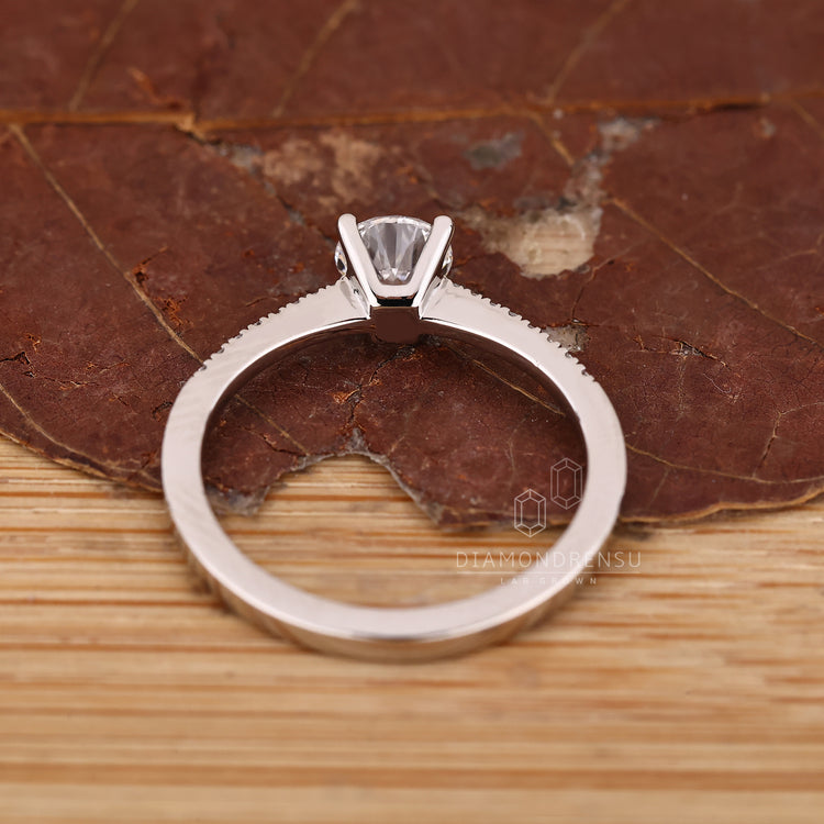 Round diamond ring pave round diamond four prong.
