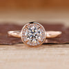 Round diamond ring halo bezel four claw prong setting.
