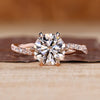 Round cut diamond ring twisted pave six claw prong.