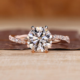 Round cut diamond ring twisted pave six claw prong.