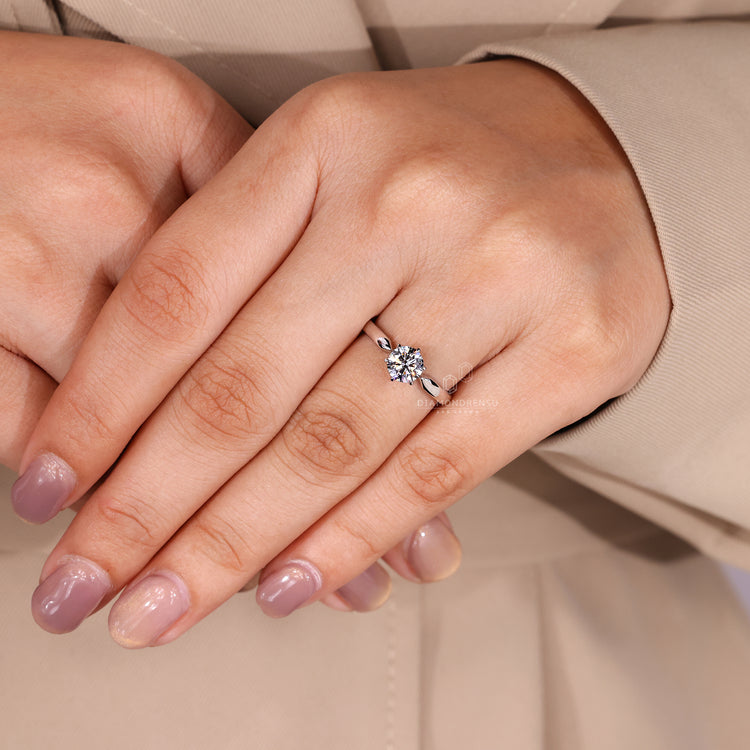 Round cut diamond ring six claw prong pinched shank.
