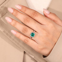 Asscher cut emerald ring round diamond channel set.
