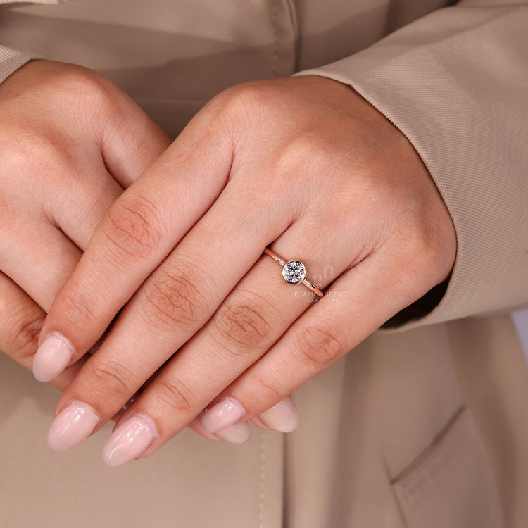 Round diamond solitaire ring with clean bezel finish.
