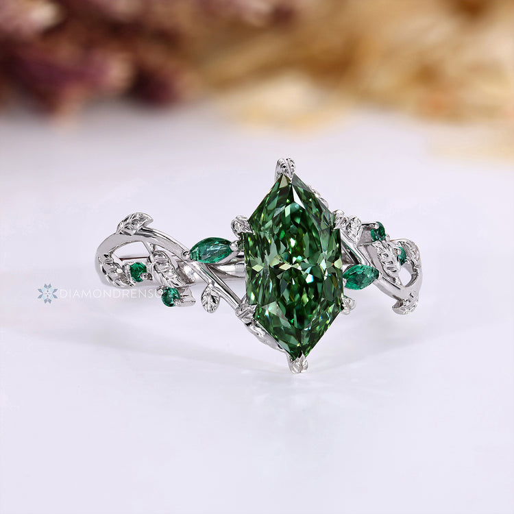 Dutch marquise ring with round green emerald side stones.