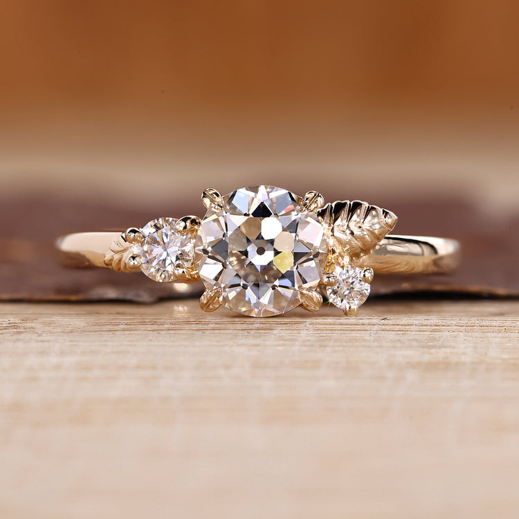 Round Old European Cut Ring with round side stones.
