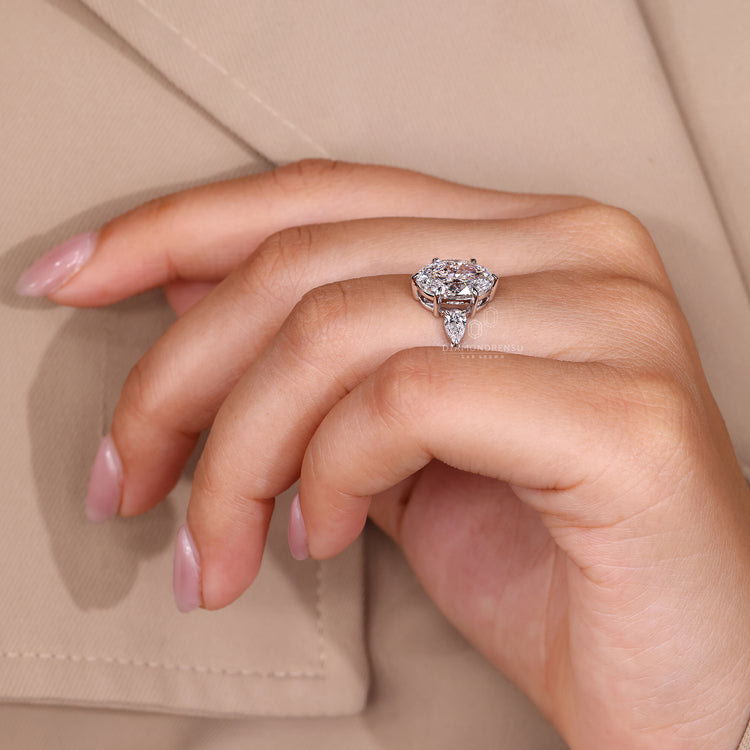 Five stone oval cut diamond ring with side stones.
