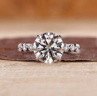 Three stone ring with blue oval center diamond.
