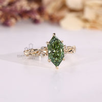 Leaf prong marquise diamond ring with round side stones.