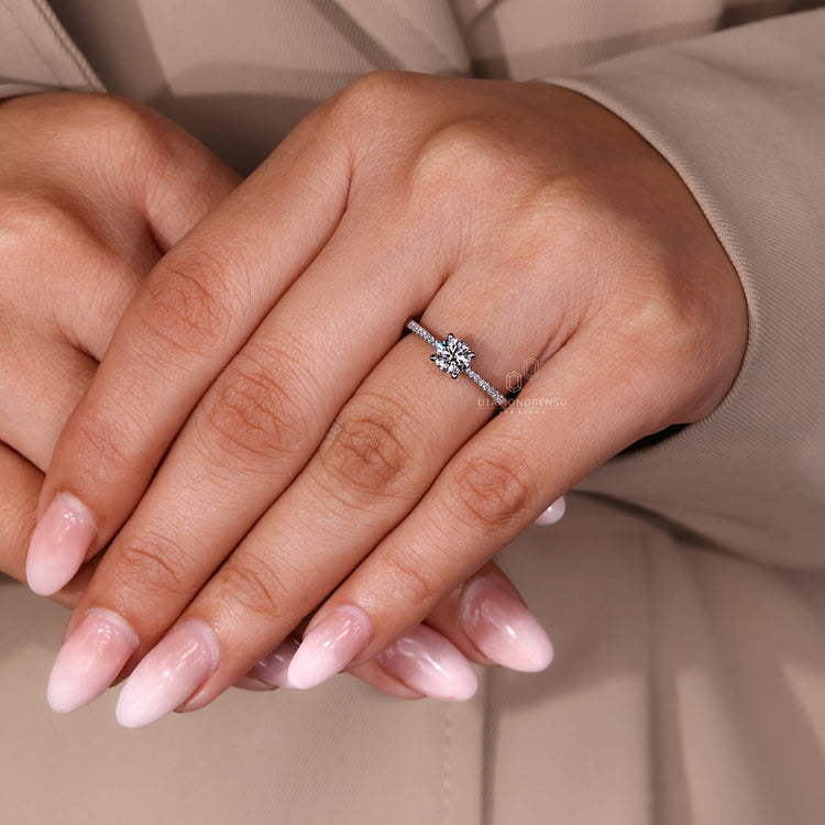 Round cut diamond ring four prong tapered shank.
