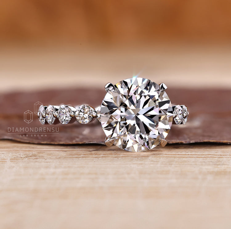 IGI certified blue oval diamond ring three stone design.
