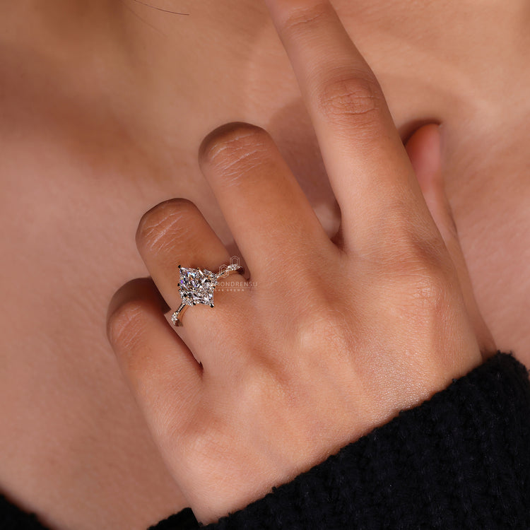 Marquise diamond ring round stones claw prong set.
