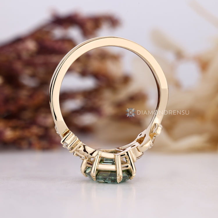 Hexagon diamond ring with round side stone accents.