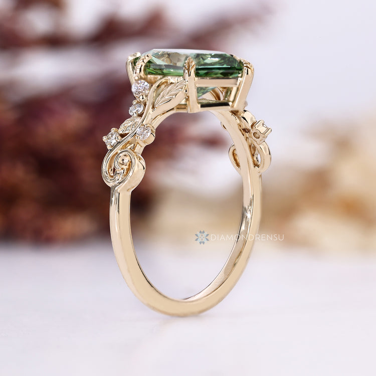Green diamond ring with marquise side stone accents.