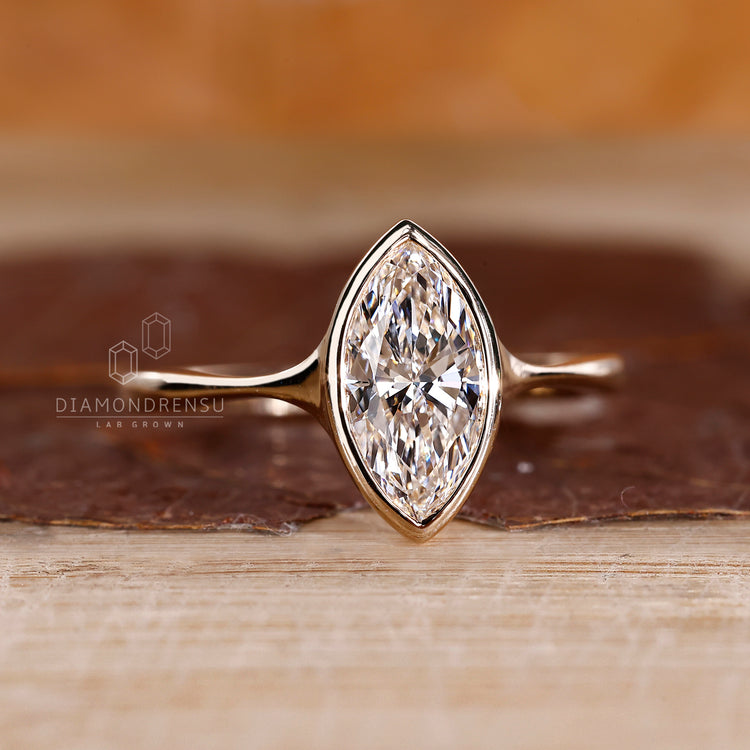 Solitaire marquise diamond ring pinch shank bezel style.
