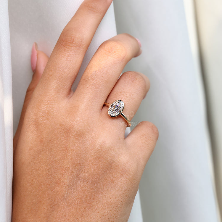 Solitaire oval old cut diamond ring eight claw prong.
