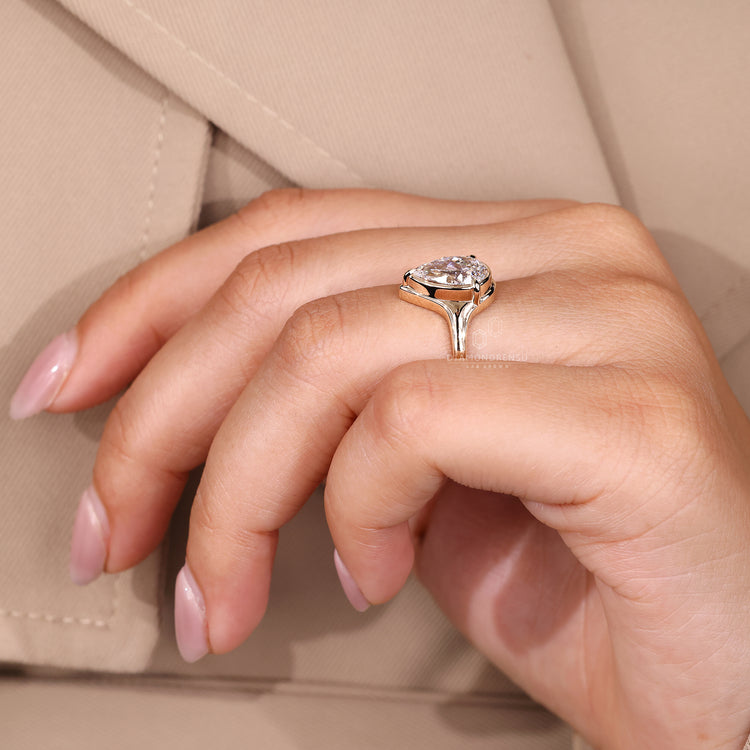 Pear cut ring bezel prong three claw setting.
