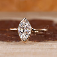 Lab grown marquise diamond ring bezel solitaire style.
