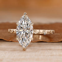 Marquise diamond ring with Art Deco floral details.