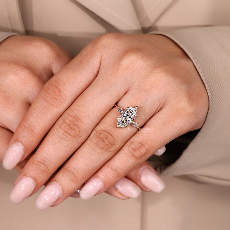 Round diamond hidden halo ring with marquise centre.