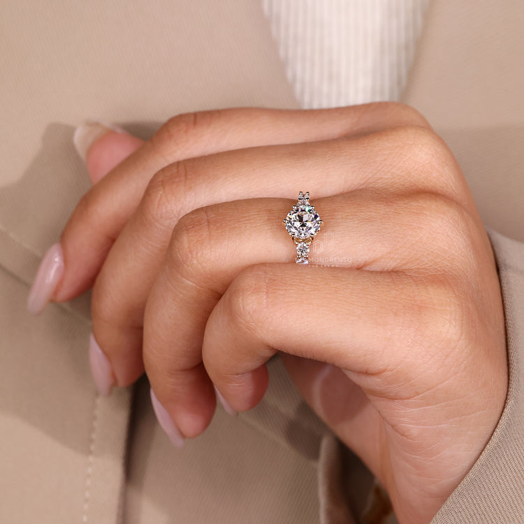 Round old cut ring side stones five stone setting.
