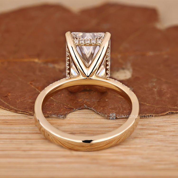 Handmade radiant diamond ring with four claw setting.