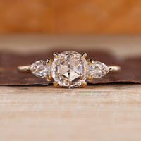 Round rose cut diamond ring with pear side stones.
