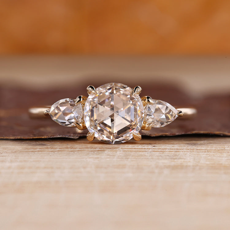 Round rose cut diamond ring with pear side stones.
