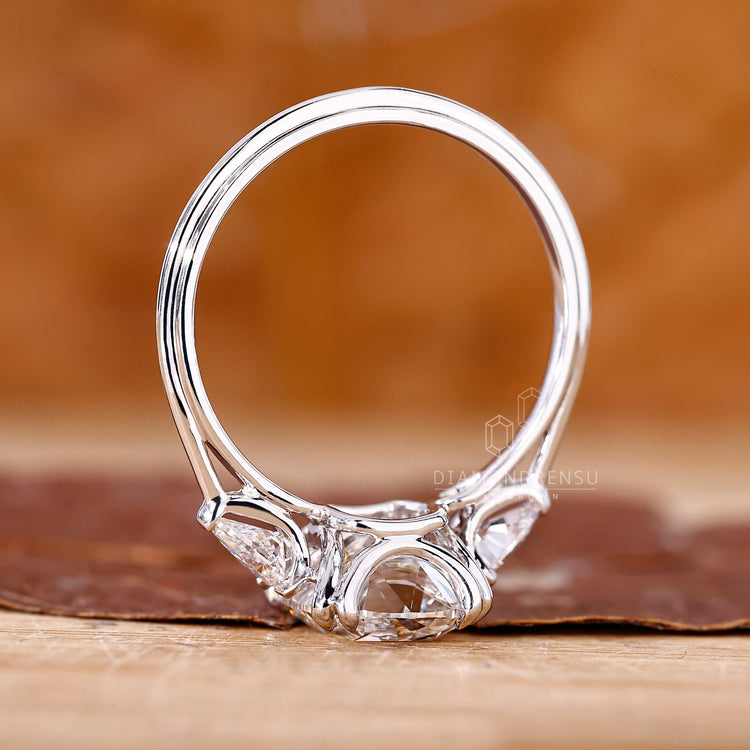Cushion Old European Cut Ring with pear side diamonds.
