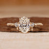 Oval cut diamond ring three stone art deco tapered shank.
