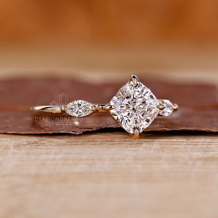 Three stone cushion diamond ring marquise side stones.

