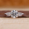 Round cut diamond ring pear side stones three stone.
