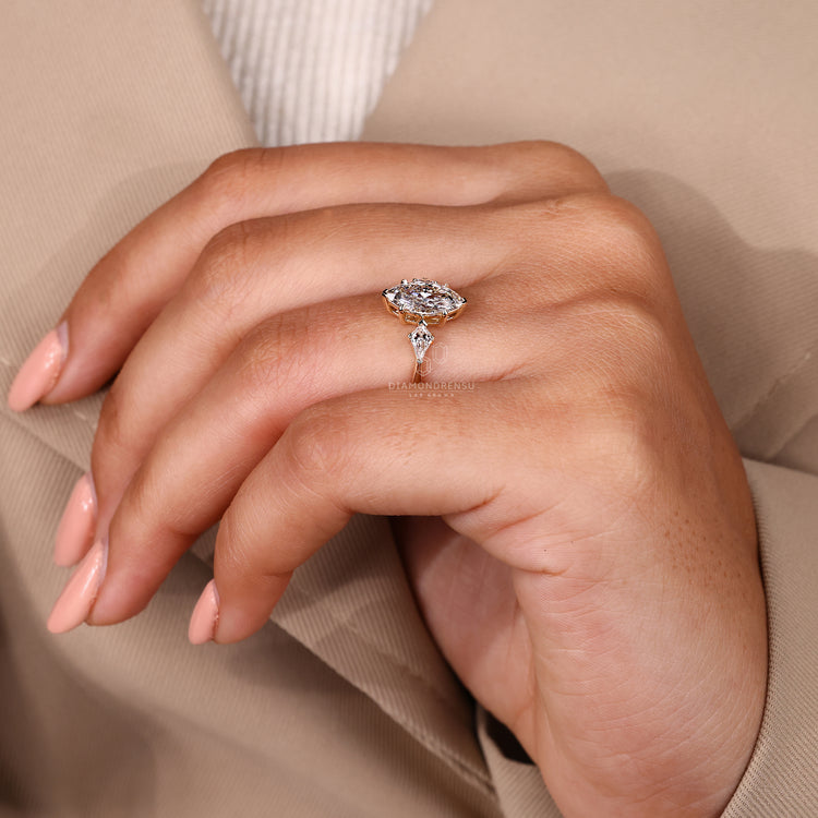 Elegant three stone diamond ring with tapered band.
