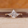 Pear cut diamond ring kite side stones art deco style.