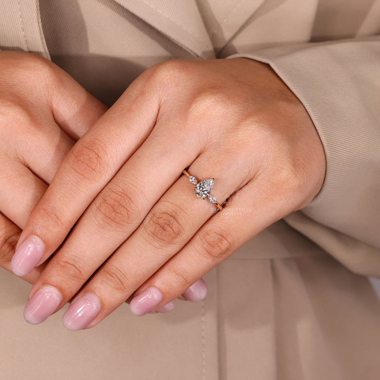 Lab grown diamond pear cut ring with marquise accents.

