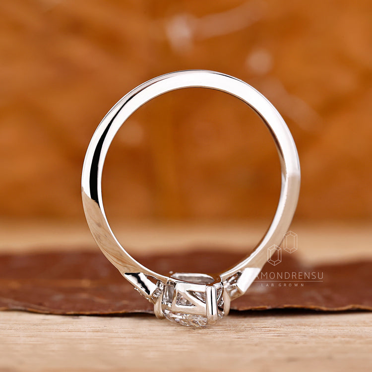 Marquise ring round side stones knife edge shank.
