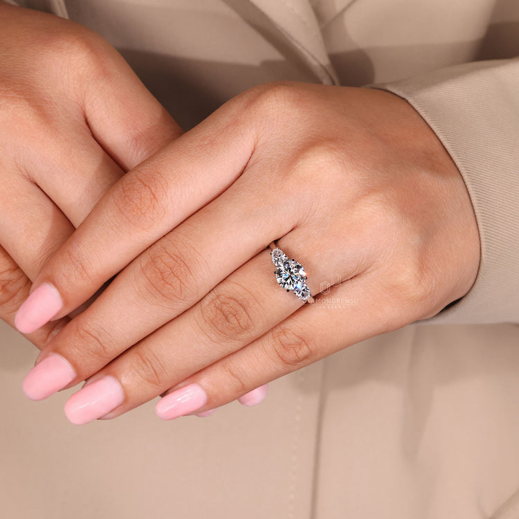 Round cut ring three stone four claw prong setting.
