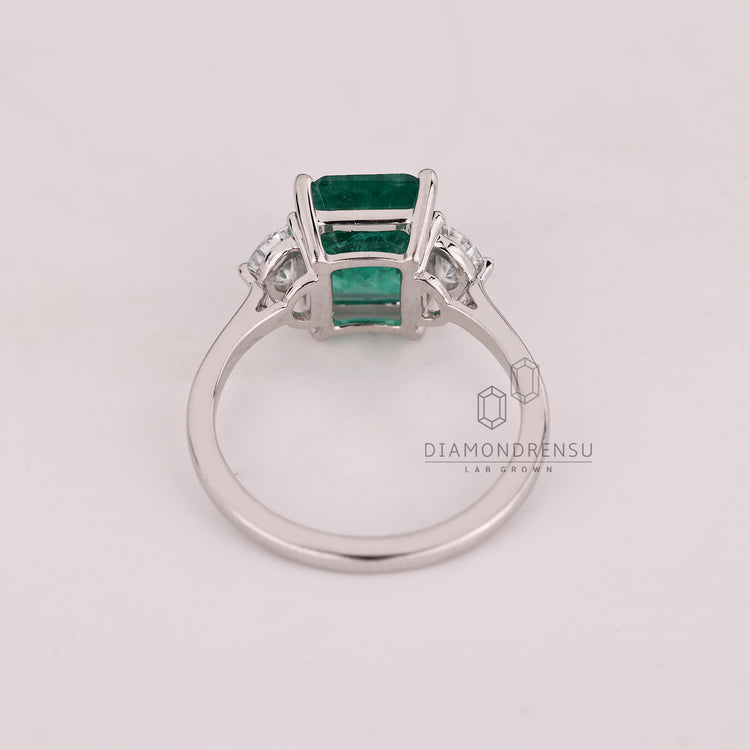 Emerald cut ring half moon stones cathedral setting.

