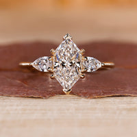 Dutch marquise diamond ring pear side stones three stone.
