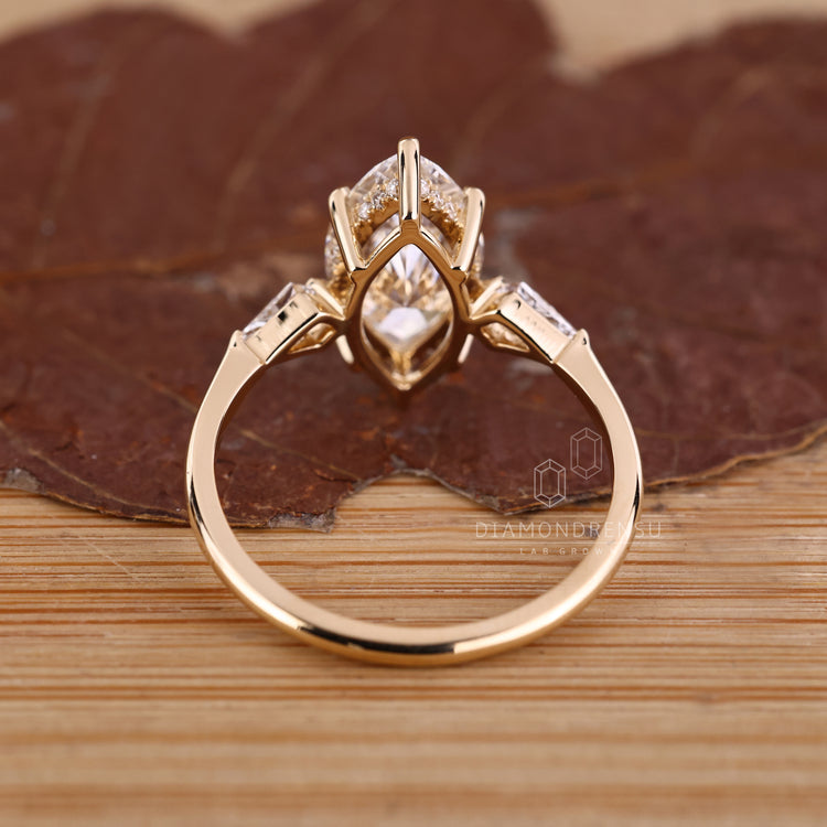 Custom diamond ring with marquise centre and kite side stones.