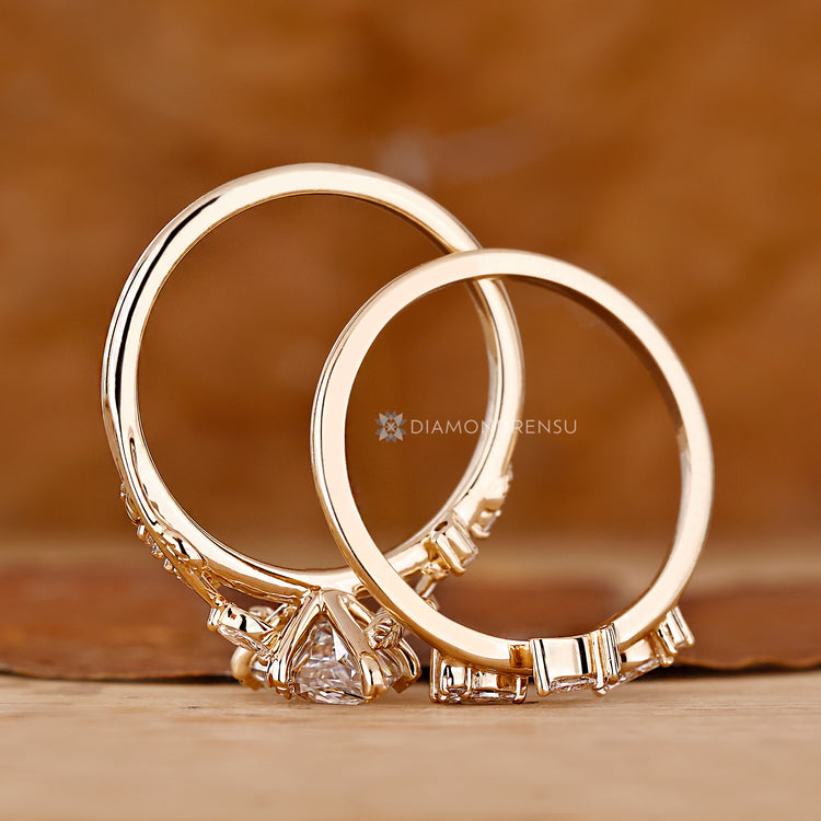 Marquise and round diamond bridal set with leaf prongs.