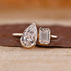 Toi et moi ring pear emerald diamond bezel prong set.
