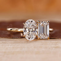 Emerald oval diamond ring claw prong two stone set.

